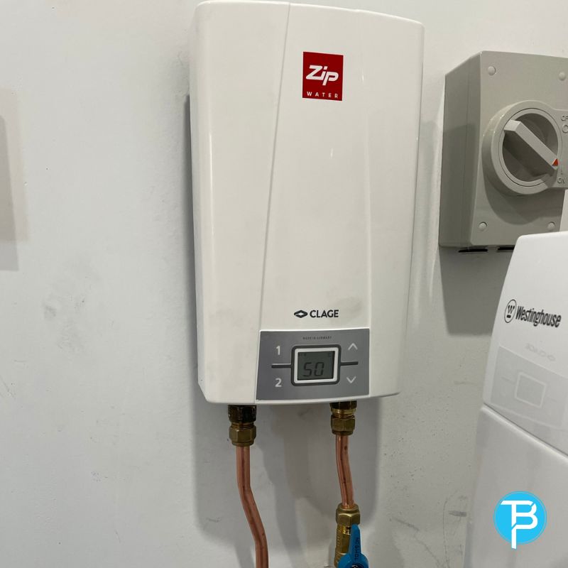 Technician repairing an electric hot water tank